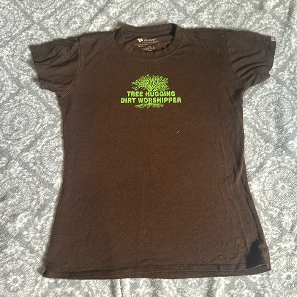 “TREE HUGGING, DIRT WORSHIPPER”
Brown T-shirt with Green lettering